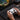 Thumbnail for Person playing a game on a laptop with a gaming controller, surrounded by gaming accessories.