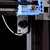 Close-up of a 3D printer's integrated camera on a black background
