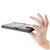 Hand holding a compact, foldable keyboard on a white background