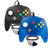 Two classic wired game controllers for the Nintendo 64/N64 on a white background: one translucent blue controller in the foreground and one solid black controller behind it. Both feature grey D-pad and face buttons, a white analog stick, and colourful red, green, blue, and yellow buttons.