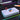Thumbnail for Gaming joystick controller on a desk with colorful lights and a smartphone in the background