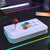 Gaming joystick controller on a desk with colorful lights and a smartphone in the background