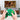 Thumbnail for A person holds a translucent green retro-style game controller for the Nintendo 64/N64 in front of a TV showing a fighting game scene. The controller has a white analog stick, a gray D-pad, yellow action buttons, and a red button, with a black cable connected.