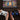 Thumbnail for Two hands holding gaming controllers in front of a tablet displaying a board game.
