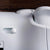 Close-up of a white Ultimate 2 Wireless controller with a control knob on a dark background
